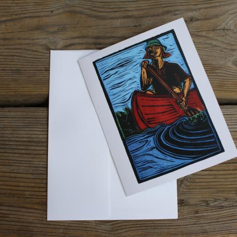 Card showing person in canoe, with envelope