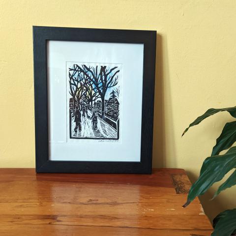 Framed Linocut print of people walking together