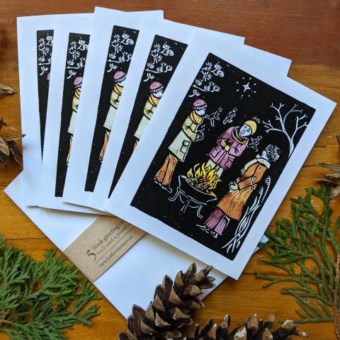 Set of 5 cards showing people visiting around a campfire in winter, with envelopes
