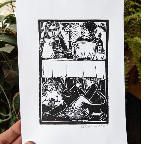 linocut print of two adults visiting at the dinner table, and kids playing cards underneath the table, while a cat steals some chips from a bowl under the table