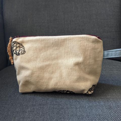 acorn dyed zipper pouch with prints of spruce cones