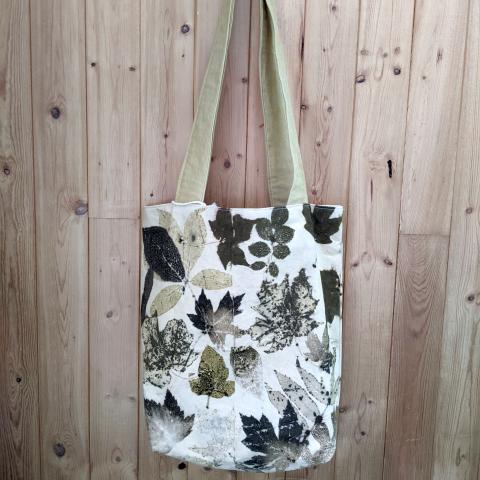 Eco-printed tote bag hung on a wall