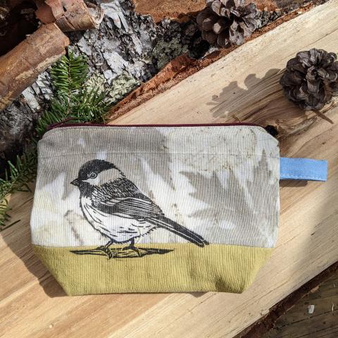 plant dyed zippered pouch that is block printed with a chickadee