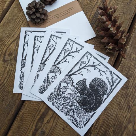 five greeting cards showing a squirrel with a food stash 