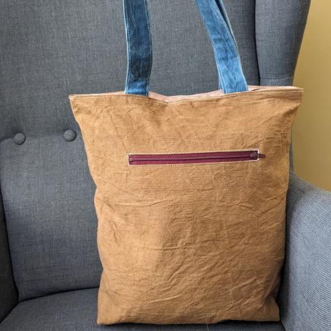Plant dyed bag with a zipper pocket