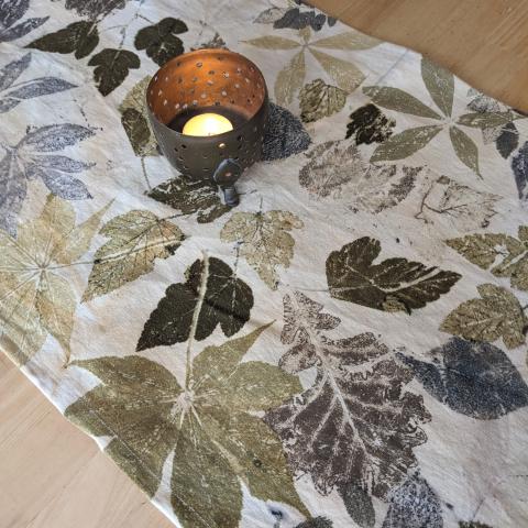 Eco-printed table runner with a candle
