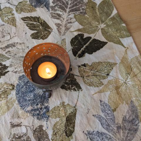 Eco-printed table runner with a candle