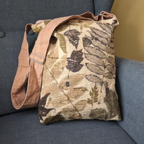 canvas bag with leaf prints and an adjustable strap