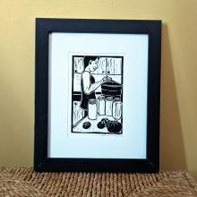 Framed print of someone canning tomatoes in the kitchen