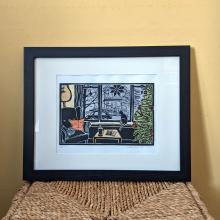 Plant ink coloured linocut print of a cozy Christmas living room