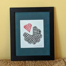 Framed print showing a waffle with one waffle heart separated out