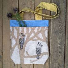PLant dyed canvas tote bag, with two bluejays sitting in the trees pictured on the side