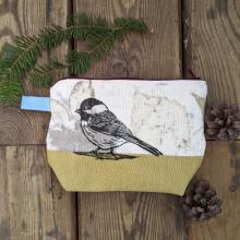 plant dyed zippered pouch that is block printed with a chickadee