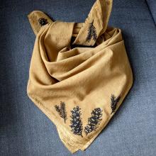 Rust coloured bandana with pine cones printed on